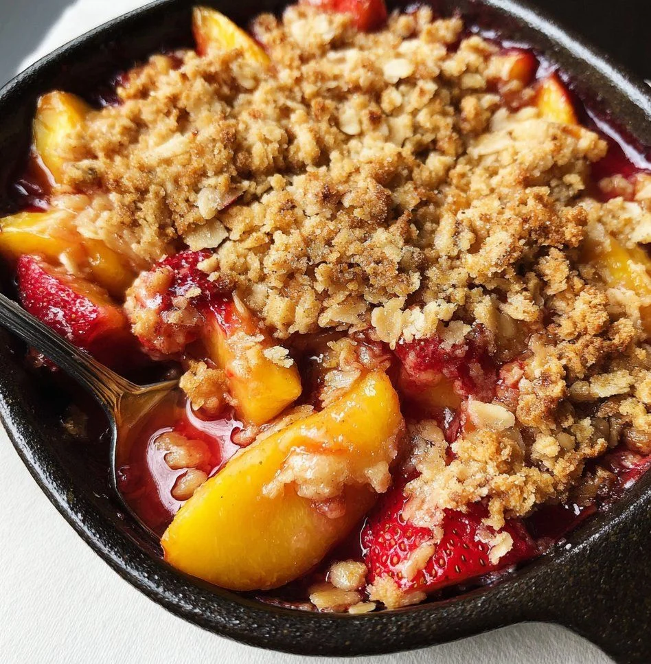 Freshly baked strawberry peach crisp topped with oat crumble